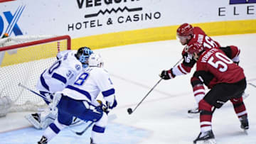 Mar 19, 2016; Glendale, AZ, USA; Arizona Coyotes center Max Domi (16) shoots the puck as center Antoine Vermette (50) looks on and Tampa Bay Lightning goalie Ben Bishop (30) and left wing Ondrej Palat (18) defend during the second period at Gila River Arena. Mandatory Credit: Matt Kartozian-USA TODAY Sports