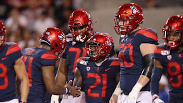 TUCSON, ARIZONA - SEPTEMBER 07: Runningback J.J. Taylor #21 of the Arizona Wildcats celebrates with quarterback Khalil Tate #14 after scoring on a 25 yard rushing touchdown against the Northern Arizona Lumberjacks during the first half of the NCAAF game at Arizona Stadium on September 07, 2019 in Tucson, Arizona. (Photo by Christian Petersen/Getty Images)