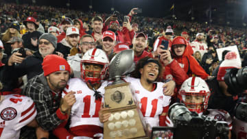 Nebraska Cornhuskers quarterback Casey Thompson (11) and defensive back Braxton Clark (11) hold the Heroes Trophy with fans( Reese Strickland-USA TODAY Sports)