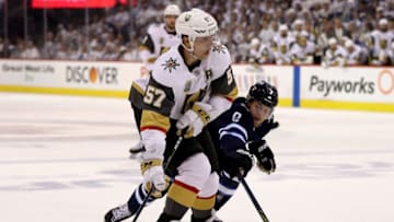 WINNIPEG, MB - MAY 12: David Perron #57 of the Vegas Golden Knights tries to keep the puck as Andrew Copp #9 of the Winnipeg Jets defends in Game One of the Western Conference Finals during the 2018 NHL Stanley Cup Playoffs at Bell MTS Place on May 12, 2018 in Winnipeg, Canada. (Photo by Elsa/Getty Images)