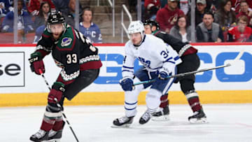 Alex Goligoski #33 of the Arizona Coyotes skates with the puck ahead of Auston Matthews #34 of the Toronto Maple Leafs during the third period of the NHL game at Gila River Arena. (Photo by Christian Petersen/Getty Images)