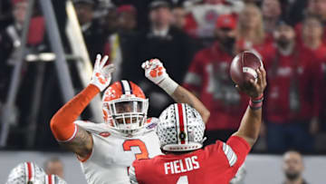 GLENDALE, ARIZONA - DECEMBER 28: Justin Fields #1 of the Ohio State Buckeyes attempts a pass against Xavier Thomas #3 of the Clemson Tigers in the first half during the College Football Playoff Semifinal at the PlayStation Fiesta Bowl at State Farm Stadium on December 28, 2019 in Glendale, Arizona. (Photo by Norm Hall/Getty Images)