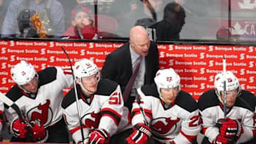 Jan 6, 2016; Montreal, Quebec, CAN; New Jersey Devils head coach John Hynes (C) talks to his team from behind the bench during the second period against Montreal Canadiens at Bell Centre. Mandatory Credit: Jean-Yves Ahern-USA TODAY Sports