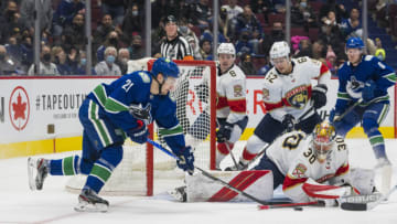 Jan 21, 2022; Vancouver, British Columbia, CAN; Florida Panthers goalie Spencer Knight (30) makes a save on Vancouver Canucks forward Nils Hoglander (21) in the first period at Rogers Arena. Mandatory Credit: Bob Frid-USA TODAY Sports