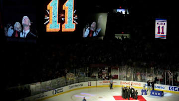 NEW YORK - JANUARY 12: Mark Messier and his son Douglas Paul are shown on the big screen watching the #11 New York Rangers banner being raised to the rafters during a ceremony in which the Rangers retired Mark's #11 at Madison Square Garden on January 12, 2006 in New York City. (Photo by Ezra Shaw/Getty Images)