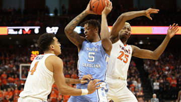 CHARLOTTESVILLE, VA - DECEMBER 07: Justin McKoy #4 and Mamadi Diakite #25 of the Virginia Cavaliers defend Armando Bacot #5 of the North Carolina Tar Heels in the first half during a game at John Paul Jones Arena on December 7, 2019 in Charlottesville, Virginia. (Photo by Ryan M. Kelly/Getty Images)