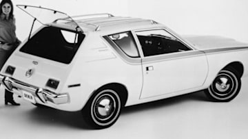 A model poses with the four-passenger 1970 AMC Gremlin with rear lift-gate and roof-top luggage rack, a two-door subcompact car measuring only a fraction more than 161 inches in overall length and boasting an unusually short turning radius of 32 feet, 8 inches, Detroit, Michigan, February 12, 1970. (Photo by Hulton Archive/Getty Images)