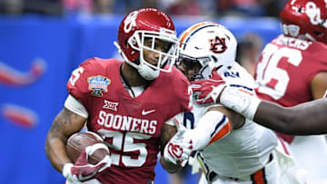 Jan 2, 2017; New Orleans , LA, USA; Oklahoma Sooners running back Joe Mixon (25) runs the ball against Auburn Tigers linebacker Darrell Williams (49) in the first quarter of the 2017 Sugar Bowl at the Mercedes-Benz Superdome. Mandatory Credit: John David Mercer-USA TODAY Sports