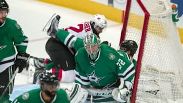 Mar 4, 2016; Dallas, TX, USA; New Jersey Devils center Reid Boucher (12) falls into center Tyler Seguin (91) as Dallas Stars goalie Kari Lehtonen (32) defends during the first period at the American Airlines Center. Mandatory Credit: Jerome Miron-USA TODAY Sports