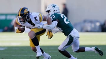 EAST LANSING, MI - SEPTEMBER 30: Wide receiver Nick Easley #84 of the Iowa Hawkeyes is tackled by cornerback Tre Person #24 of the Michigan State Spartans during the first half at Spartan Stadium on September 30, 2017 in East Lansing, Michigan. Michigan State defeated Iowa 17-7. (Photo by Duane Burleson/Getty Images)