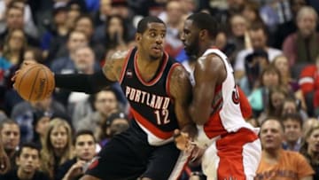 Mar 15, 2015; Toronto, Ontario, CAN; Portland Trail Blazers forward LaMarcus Aldridge (12) is guarded by Toronto Raptors forward Patrick Patterson (54) as he controls the ball at Air Canada Canada Centre. The Trail Blazers beat the Raptors 113-97. Mandatory Credit: Tom Szczerbowski-USA TODAY Sports