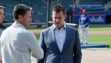 NEW YORK, NY - MAY 20: Chief Operating Officer Jeff Wilpon and General Manager Brody Van Wagenen of the New York Mets, talk on the field during batting practice moments after Van Wagenen held a press conference before an MLB baseball game against the Washington Nationals on May 20, 2019 at Citi Field in the Queens borough of New York City. Mets won 5-3. (Photo by Paul Bereswill/Getty Images)