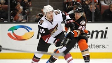 November 9, 2015; Anaheim, CA, USA; Arizona Coyotes defenseman Stefan Elliott (45) moves the puck against Anaheim Ducks left wing Carl Hagelin (26) during the second period at Honda Center. Mandatory Credit: Gary A. Vasquez-USA TODAY Sports