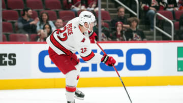 Apr 18, 2022; Glendale, Arizona, USA; Carolina Hurricanes defenseman Brett Pesce (22) passes the puck against the Arizona Coyotes during the first period at Gila River Arena. Mandatory Credit: Joe Camporeale-USA TODAY Sports
