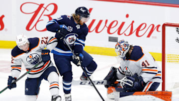 Apr 17, 2021; Winnipeg, Manitoba, CAN; Edmonton Oilers defenseman Tyson Barrie (22) and Winnipeg Jets left wing Kyle Connor (81) jump from the puck in front of Edmonton Oilers goaltender Mike Smith (41) in the second period at Bell MTS Place. Mandatory Credit: James Carey Lauder-USA TODAY Sports