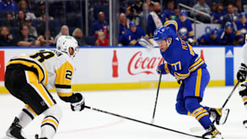 Oct 6, 2023; Buffalo, New York, USA; Buffalo Sabres right wing JJ Peterka (77) skates with the puck as Pittsburgh Penguins defenseman Marcus Pettersson (28) looks to defend during the second period at KeyBank Center. Mandatory Credit: Timothy T. Ludwig-USA TODAY Sports