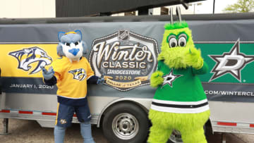 DALLAS, TX - MARCH 20: Gnash of the Nashville Predators and Victor E. Green of the Dallas Stars pose for a photo as the Dallas Stars and the NHL host a press conference for the upcoming Bridgestone Winter Classic 2020 at the Cotton Bowl on March 20, 2019 in Dallas, Texas. (Photo by Glenn James/NHLI via Getty Images)