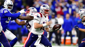 Dec 18, 2021; Indianapolis, Indiana, USA; New England Patriots quarterback Mac Jones (10) looks for a teammate after the snap during the first quarter against the Indianapolis Colts at Lucas Oil Stadium. Mandatory Credit: Marc Lebryk-USA TODAY Sports