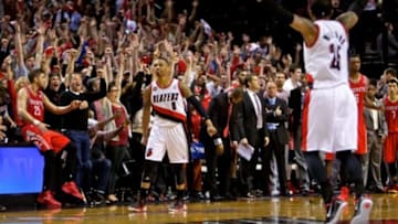 May 2, 2014; Portland, OR, USA; Portland Trail Blazers guard Damian Lillard (0) reacts after hitting the game winning shot against the Houston Rockets during the fourth quarter in game six of the first round of the 2014 NBA Playoffs at the Moda Center. Mandatory Credit: Craig Mitchelldyer-USA TODAY Sports
