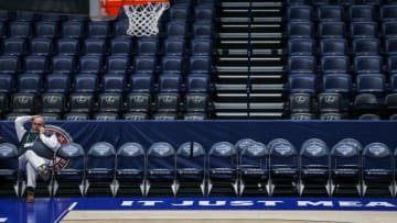 Rob Thomas, an employee with CSE Sports, talks on the phone from a team bench after the SEC announced Thursday morning the cancellation of the 2020 SEC men's college basketball tournament at Bridgestone Arena. The SEC Conference announced the cancellation of the 2020 SEC Men's College Basketball Tournament after the COVID-19 outbreak. March 12, 2020.Sec Tournament