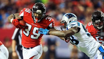 Dec 29, 2013; Atlanta, GA, USA; Atlanta Falcons running back Steven Jackson (39) stiff arms Carolina Panthers linebacker Thomas Davis (58) on a run in the first half at the Georgia Dome. Mandatory Credit: Daniel Shirey-USA TODAY Sports