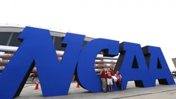 Apr 8, 2013; Atlanta, GA, USA; Fans take photos in front of a giant NCAA logo before the championship game in the 2013 NCAA mens Final Four at the Georgia Dome. Mandatory Credit: Daniel Shirey-USA TODAY Sports