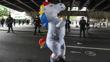PORTLAND, OR - AUGUST 17: A person dressed as a unicorn dances in front of police officers during an alt-right rally on August 17, 2019 in Portland, Oregon. Anti-fascism demonstrators gathered to counter-protest a rally held by far-right, extremist groups. (Photo by Stephanie Keith/Getty Images)