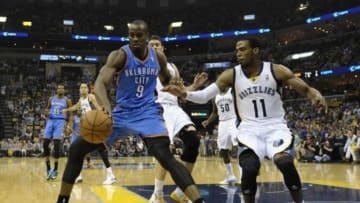 Apr 24, 2014; Memphis, TN, USA; Oklahoma City Thunder forward Serge Ibaka (9) handles the ball against Memphis Grizzlies guard Mike Conley (11) in game three of the first round of the 2014 NBA Playoffs at FedExForum. Mandatory Credit: Justin Ford-USA TODAY Sports