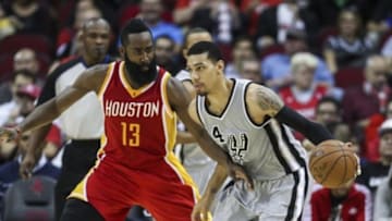 Nov 6, 2014; Houston, TX, USA; San Antonio Spurs guard Danny Green (14) controls the ball during the third quarter as Houston Rockets guard James Harden (13) defends at Toyota Center. Mandatory Credit: Troy Taormina-USA TODAY Sports