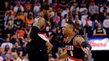Mar 27, 2015; Phoenix, AZ, USA; Portland Trail Blazers forward LaMarcus Aldridge (12) celebrates with guard Damian Lillard (0) after making a basket against the Phoenix Suns during the second half at US Airways Center. The Trail Blazers won the game 87-81. Mandatory Credit: Joe Camporeale-USA TODAY Sports