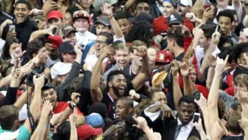 Feb 17, 2016; Lubbock, TX, USA; Texas Tech Red Raiders forward Aaron Ross (15) is engulfed by the Red Raider student body after defeating the Oklahoma Sooners 65-63 at United Supermarkets Arena. Mandatory Credit: Michael C. Johnson-USA TODAY Sports