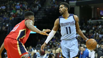 Jan 18, 2016; Memphis, TN, USA; Memphis Grizzlies guard Mike Conley (11) dribbles as New Orleans Pelicans guard Norris Cole (30) defends at FedExForum. Memphis defeated New Orleans 101-99. Mandatory Credit: Nelson Chenault-USA TODAY Sports