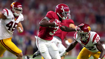 ARLINGTON, TX - SEPTEMBER 3: Calvin Ridley #3 of the Alabama Crimson Tide stiff arms Leon McQuay III #22 of the USC Trojans as Porter Gustin #45 of the USC Trojans looks on in the first half during the AdvoCare Classic at AT&T Stadium on September 3, 2016 in Arlington, Texas. (Photo by Tom Pennington/Getty Images)