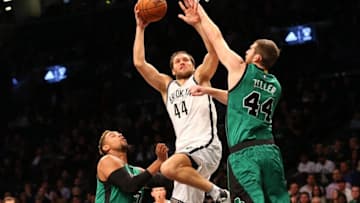 Jan 4, 2016; Brooklyn, NY, USA; Boston Celtics center Tyler Zeller (44) keeps Brooklyn Nets guard Bojan Bogdanovic (44) from the net during the second quarter at Barclays Center. Mandatory Credit: Anthony Gruppuso-USA TODAY Sports