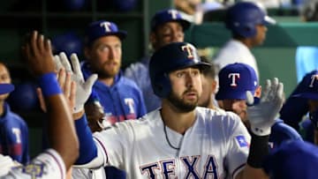 ARLINGTON, TEXAS - APRIL 15: Joey Gallo #13 of the Texas Rangers gets high fives in the dugout after a solo home run in the third inning against the Los Angeles Angels at Globe Life Park in Arlington on April 15, 2019 in Arlington, Texas. All players are wearing the number 42 in honor of Jackie Robinson Day. (Photo by Richard Rodriguez/Getty Images)