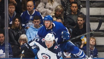 TORONTO, ON - OCTOBER 27: Brendan Lemieux #48 of the Winnipeg Jets checks Martin Marincin #52 of the Toronto Maple Leafs during the third period at the Scotiabank Arena on October 27, 2018 in Toronto, Ontario, Canada. (Photo by Mark Blinch/NHLI via Getty Images)