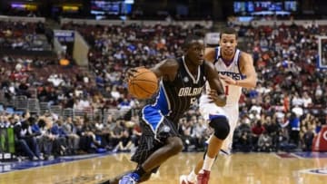Dec 3, 2013; Philadelphia, PA, USA; Orlando Magic guard Victor Oladipo (5) is defended by Philadelphia 76ers guard Michael Carter-Williams (1) during the third quarter at the Wells Fargo Center. The Sixers defeated the Magic 126-125 in double overtime. Mandatory Credit: Howard Smith-USA TODAY Sports