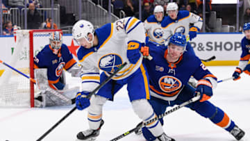 Mar 7, 2023; Elmont, New York, USA; New York Islanders defenseman Scott Mayfield (24) defends against Buffalo Sabres right wing Jack Quinn (22) during the third period at UBS Arena. Mandatory Credit: Dennis Schneidler-USA TODAY Sports