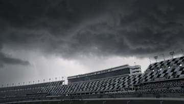 DAYTONA BEACH, FL - JULY 06: Fans take shelter during a rain delay prior to qualifying for the NASCAR Xfinity Series Coca-Cola Firecracker 250 at Daytona International Speedway on July 6, 2018 in Daytona Beach, Florida. (Photo by Sean Gardner/Getty Images)