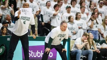 Michigan State coach Tom Izzo watches a play as assistant coach Mark Montgomery holds up a sign during the second half of MSU's 80-65 win on Tuesday, Feb. 21, 2023, at Breslin Center.