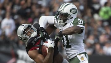 November 1, 2015; Oakland, CA, USA; New York Jets cornerback Antonio Cromartie (31) tackles Oakland Raiders wide receiver Michael Crabtree (15) during the second quarter at O.co Coliseum. Mandatory Credit: Kyle Terada-USA TODAY Sports