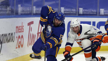 Feb 16, 2021; Buffalo, New York, USA; Buffalo Sabres center Tobias Rieder (13) goes after the puck as New York Islanders defenseman Andy Greene (4) defends during the second period at KeyBank Center. Mandatory Credit: Timothy T. Ludwig-USA TODAY Sports