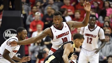 Nov 30, 2016; Louisville, KY, USA; Purdue Boilermakers guard P.J. Thompson (11) dribbles against Louisville Cardinals forward Jaylen Johnson (10) during the second half at KFC Yum! Center. Louisville defeated Purdue 71-64. Mandatory Credit: Jamie Rhodes-USA TODAY Sports