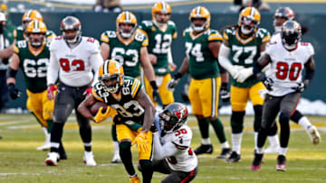 Jan 24, 2021; Green Bay, Wisconsin, USA; Green Bay Packers wide receiver Marquez Valdes-Scantling (83) runs the ball against former Auburn football cornerback Jamel Dean (35) during the second quarter in the NFC Championship Game at Lambeau Field. Mandatory Credit: Jeff Hanisch-USA TODAY Sports