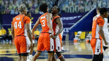Illinois guard Da'Monte Williams (20) and guard Jacob Grandison (3) celebrate a play against Michigan during the first half Tuesday, March 2, 2021, at the Crisler Center in Ann Arbor.illinois basketball happy michigan sad
