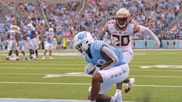 CHAPEL HILL, NORTH CAROLINA - OCTOBER 09: Kamari Morales #88 of the North Carolina Tar Heels makes a touchdown catch against Kalen DeLoach #20 of the Florida State Seminoles during the second half of their game at Kenan Memorial Stadium on October 09, 2021 in Chapel Hill, North Carolina. (Photo by Grant Halverson/Getty Images)