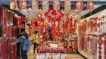 TAIPEI, TAIWAN - FEBRUARY 10: Shoppers look for decorations to buy on February 10, 2021 as people prepare for Chinese New Year at Dihua Street in Taipei, Taiwan. Ethnic Chinese around the world are celebrating a somewhat subdued Lunar New Year, as Covid-19 restrictions cut into what is traditionally a time for people to meet their relatives and take part in celebrations with extended families. The Dihua Street market in Taiwan's capital was still operating, though with activities such as food sampling banned. The wearing of masks was also enforced, though Taiwan has been spared the worst of the pandemic. (Photo by An Rong Xu/Getty Images)
