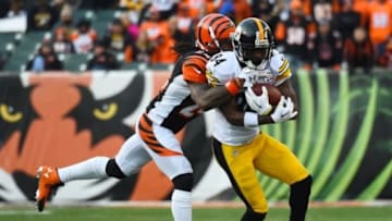 Dec 7, 2014; Cincinnati, OH, USA; Pittsburgh Steelers wide receiver Antonio Brown (84) makes a catch against Cincinnati Bengals cornerback Adam Jones (24) during the second half at Paul Brown Stadium. Pittsburgh Steelers defeat the Cincinnati Bengals 42-21. Mandatory Credit: Mike DiNovo-USA TODAY Sports