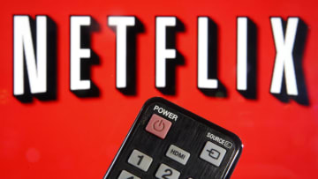 PARIS, FRANCE - MARCH 28: In this photo illustration, a remote control is seen in front of a television screen showing a Netflix logo on March 28, 2020 in Paris, France. Faced with the coronavirus crisis, Netflix will reduce visual quality for the next 30 days, in order to limit its use of bandwidth. (Photo Illustration by Chesnot/Getty Images)