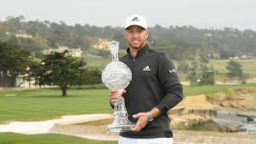 PEBBLE BEACH, CALIFORNIA - FEBRUARY 14: Daniel Berger of the United States celebrates with the trophy after winning during the final round of the AT&T Pebble Beach Pro-Am at Pebble Beach Golf Links on February 14, 2021 in Pebble Beach, California. (Photo by Harry How/Getty Images)